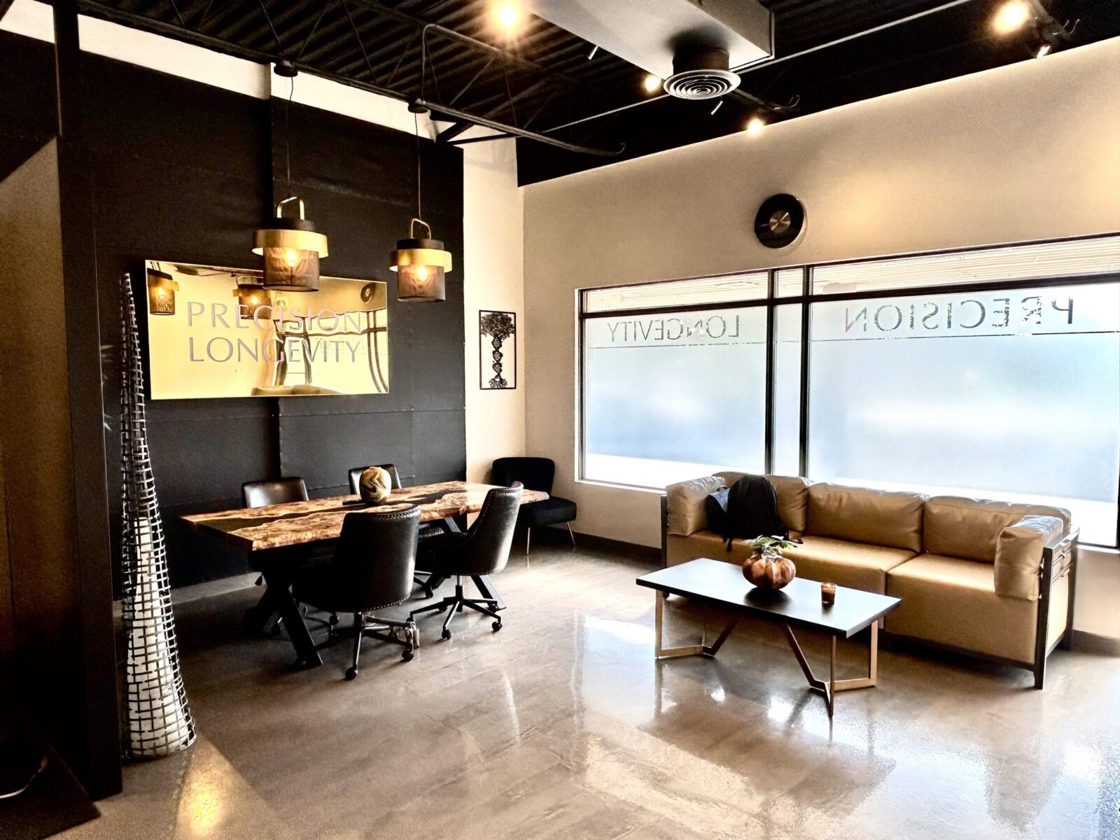 A black and gold office with a table and chairs.